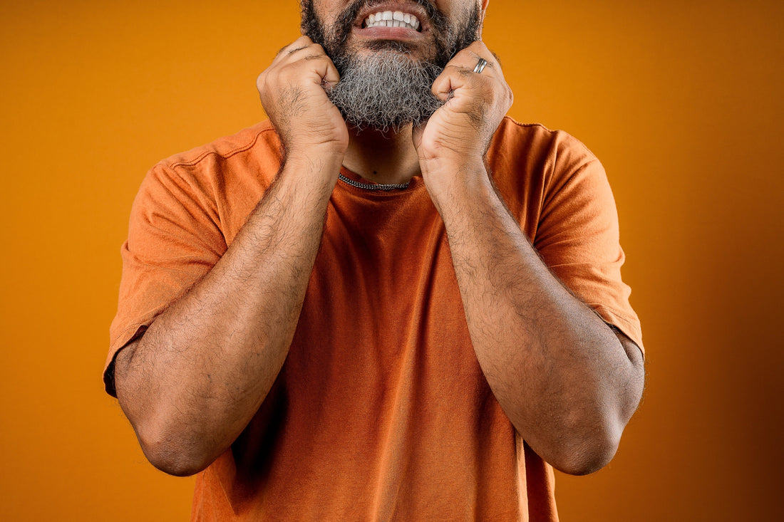 man pulling on his beard