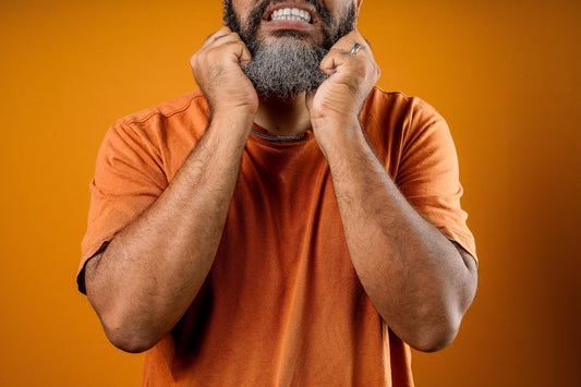 man pulling on his beard